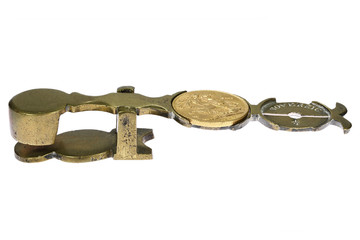 British full Sovereign gold coin on Sovereign weighing scale isolated on white background