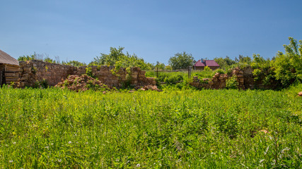 destroyed stone walls in the village