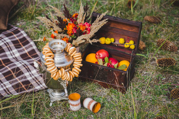 Apples in a box on the grass and bouquet