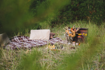 Bouquet and apples in a box on the grass