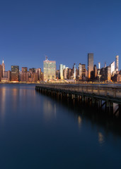View on Midtown Manhattan from East river pier during sunrise with long exposure