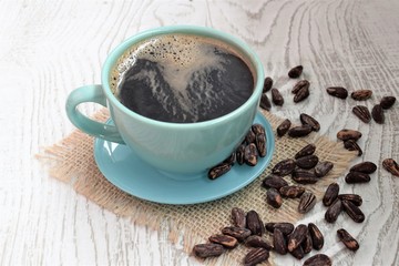 cup of coffee and beans on wooden table