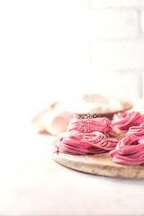 Fresh Hand made beetroot pasta on wooden cutting board. Raw purple spaghetti, fettuccine.