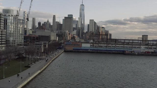 Aerial dolly in shot of New York downtown over Hudson river parkway during pandemic