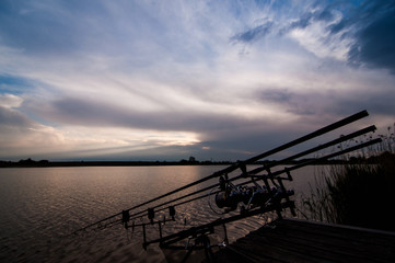 Fototapeta na wymiar Fishing adventures, carp fishing at dawn. Professional fishing equipment