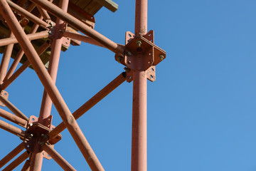 Fototapeta premium Scaffolding Elements Construction. Metal scaffolding tubes and bars. Construction site details. Bridge support. Industrial background.