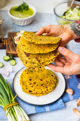 Flatbread stuffed with green herbs and garlic. Vegan food or vegetarian meal. Woman hands