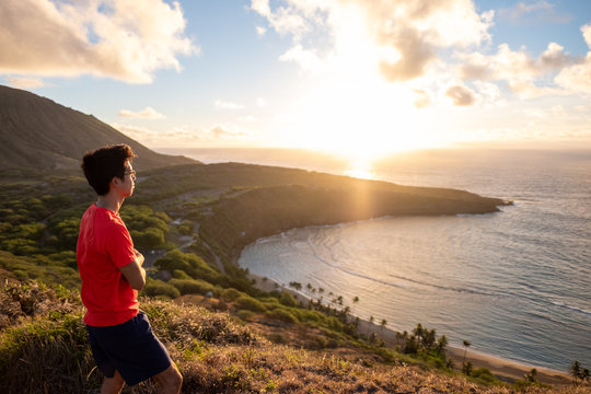 Man looking off to the horizon - future - Hanama Bay sunrise - golden hour - over pacific ocean