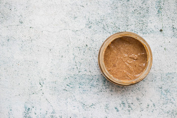 Homemade creamy peanut bar in glass jar. Copy space.