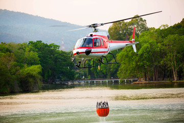 The helicopter is drawing water from the reservoir and will be watered to extinguish the burning...