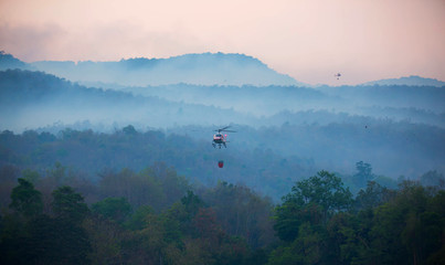 The helicopter is drawing water from the reservoir and will be watered to extinguish the burning...