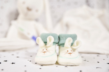 white and green bunny baby booties. concept baby on the way.