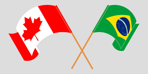 Crossed and waving flags of Brazil and Canada