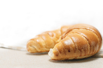 Croissant for breakfast and bright background.