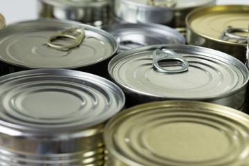 many cans with meals such as meat and fish on the table, conserved food, close up