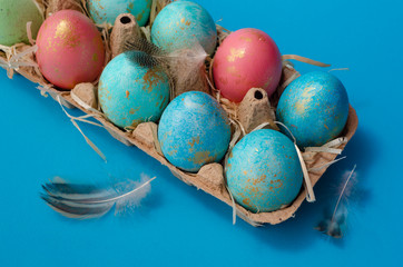 Easter background. Easter eggs in paper container. Painted Easter eggs. Easter holiday postcard minimalism concept.