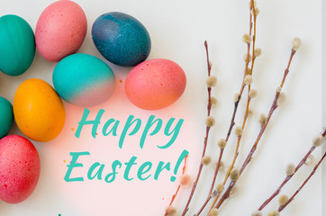 greeting card with willow branches with colored easter eggs