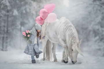Little girl with with flowers bouquet and white horse in winter forest