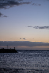 Man fishing during Sunset over pacific ocean silhouette, honolulu, HI, September 11, 2018
