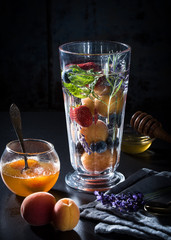 A glass of clean water, fruits, mint and lavender