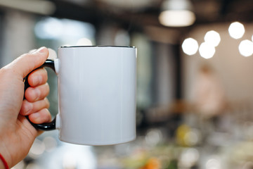 hand holds a cup