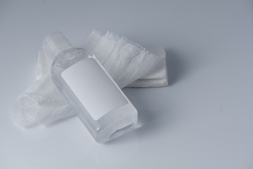 White medical cotton gauze bandage and antiseptic gel on white, gray background, Medical bandage of new first aid gauze unrolling