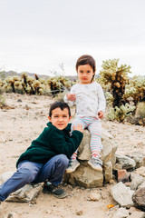 Brother and Sister Exploring Desert Landscape
