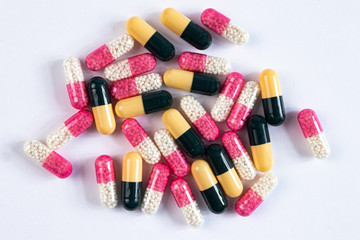colorful drugs and capsules on a white background