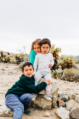 Siblings Exploring Desert Landscape