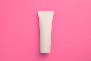 Natural cosmetic in white tube, skincare concept in the middle of pink background