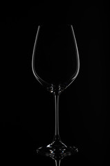 Silhouette of an empty wine glass against black background with reflection in Zurich, Europe, Switzerland.