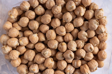 a lot of dried chickpeas for making hummus on a white background