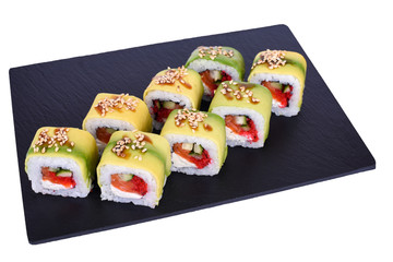 sushi rolls on a black stone Green Dragon on a white background. Roll ingredients: avocado, salmon, philadelphia cheese, cucumber, red tobiko caviar, unagi sauce, sesame mix, nori, rice.