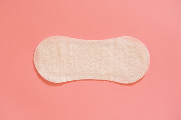Menstrual cycle. White feminine pad on a pink background.