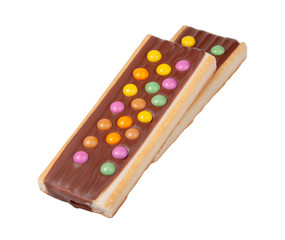 Chocolate bar snack with colorful drops or dragee isolated on the white