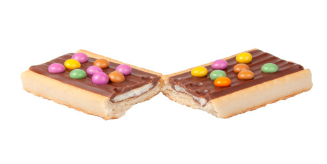 Chocolate bar snack with colorful drops or dragee isolated on the white