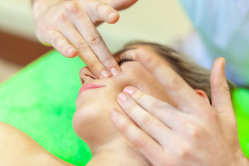 Obraz na płótnie Canvas Photo of a part of face of calm female during luxurious procedure of massage