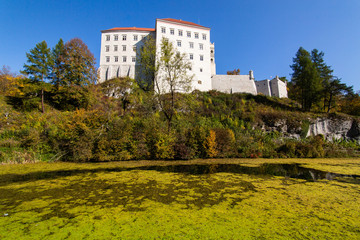 Historic castle Pieskowa Skala near Krakow in Poland. Aerial view in fall at sunrise in morning fog.
