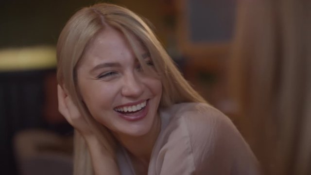 Slowmo shot of happy blond woman talking to her mother and laughing