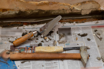 Trowel and cement on the newspaper. Construction works. Home repair. Do it yourself.