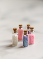 small jars with sequins for artwork on a light background