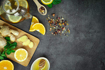 Ginger tea with lemon, honey and mint on grey concrete background. Top view, flat lay, copy space