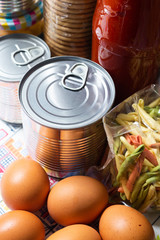 Food pantry basics for coronavirus quarantine with canned, pasta, eggs, sauce