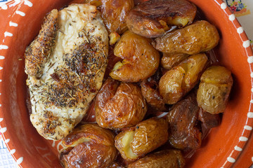 Rustic baked chicken breast with roasted and punched potatoes
