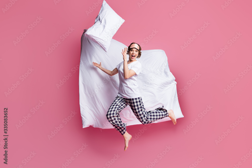 Canvas Prints Full size photo of funny lady jump high throw pillow up blanket flight rejoicing slumber party wear sleep mask white t-shirt plaid pajama pants barefoot isolated pink color background