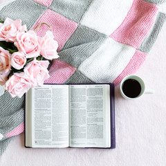 Pink Bible flat lay: Bouquet of pink roses, open Bible, black tea, coffee, journal, notebook, pen...