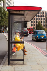 tourist at the bus stop waiting on the bus