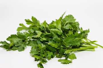 green bunch of parsley on a white background close up