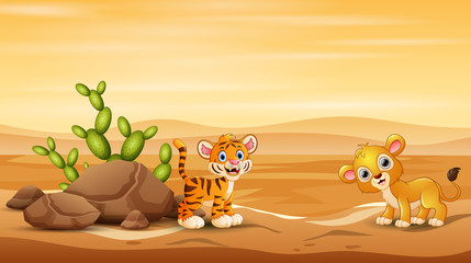 Baby tiger and lion playing at desert landscape