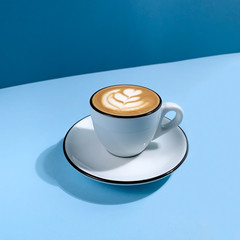 Cup of coffee on blue background